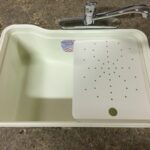 Under-surface cutting board with right or left drain holes – versatile kitchen accessory