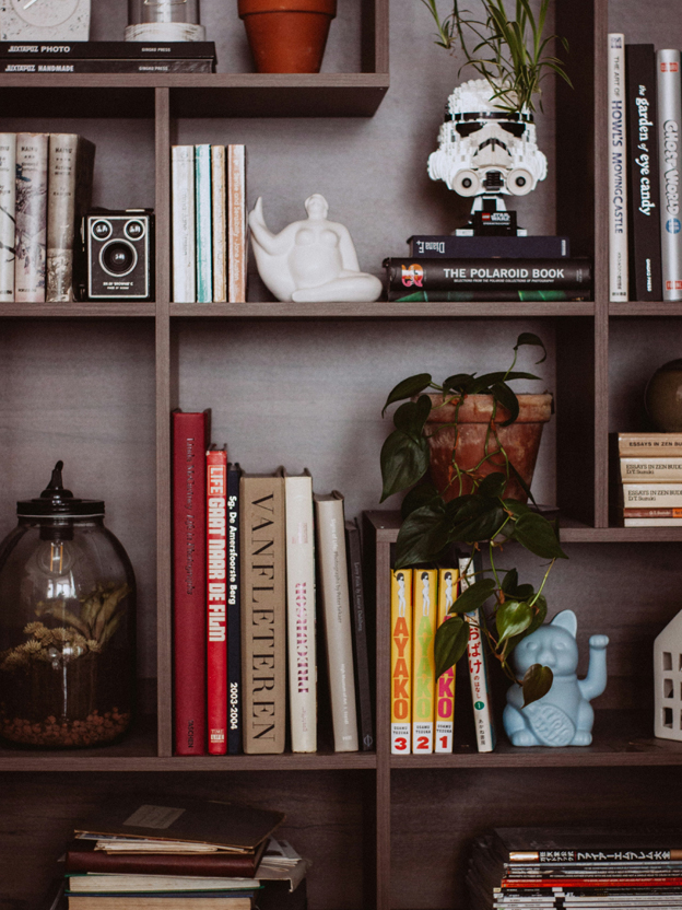 Wooden bookshelf filled with books and decorative home items